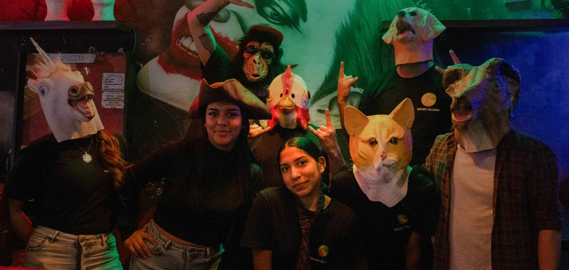 A festive group of people wearing funny animal masks and posing playfully for the camera.